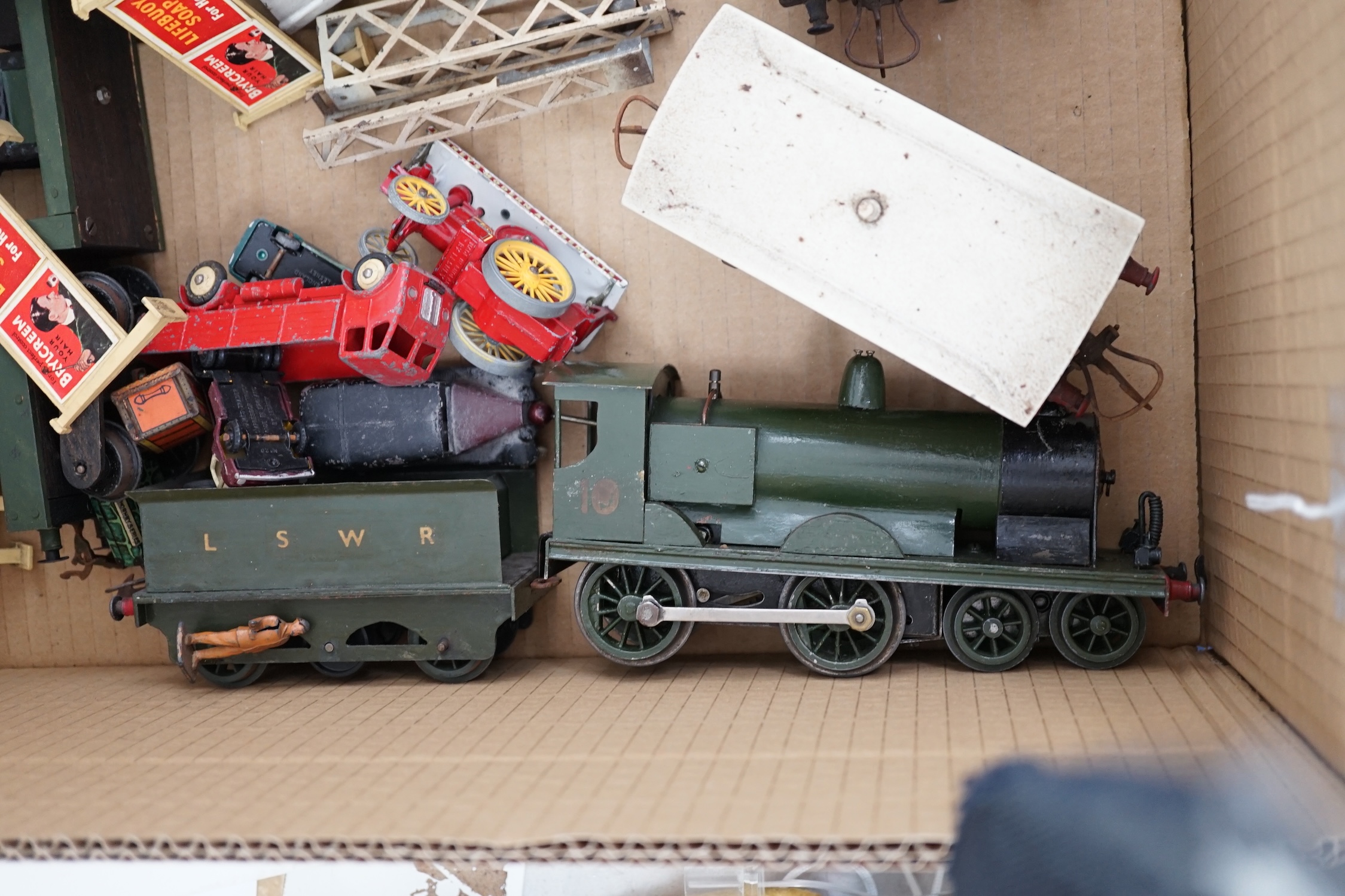 Fourteen 0 gauge tinplate etc. railway items, including three clockwork locomotives; an LSWR 4-4-0 tender loco, an SR 0-4-4T loco and an SR 0-4-2T loco, together with nine Hornby freight wagons, a Bing milk traffic van a